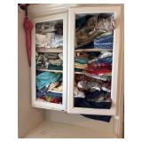 Cabinet contentsof pillow cases blankets and more