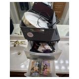 Clocks storage drawers books and hair supplies