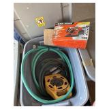Tote with garden hoses and sander and extension