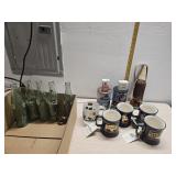 Whiskey mugs, coffee  tins, and old bottles
