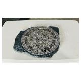 Silver color Aztec calendar on dark plaque