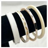 A Gathering of 4 White Bangles