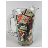 Glass Pitcher Filled With Matchbooks