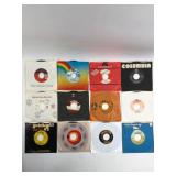12 45 RPM Vinyl Records In Sleeves