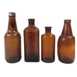Group of Four Vintage Amber Glass Bottles