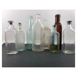 8 Vintage Embossed Glass Bottles