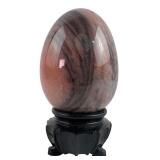 Polished Pink Stone Egg on Carved Wood Stand