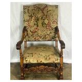 Carved wooden armchair with needlepoint upholstery
