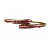 JEWELRY. 14kt Gold and Ruby Bypass Style Bracelet.