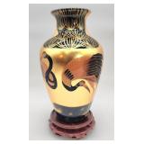 Unique gold tone Asian vase on a wooden stand