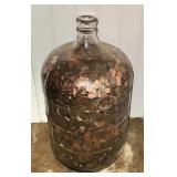 5 gallon glass jug full of pennies