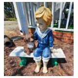 Resin boy w dog on bench garden decor