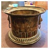 Patinated metal planter lions heads