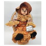 Faith Wick scarecrow in a wicker chair