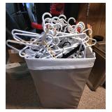 hamper full of clothes hangers