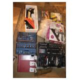 Assortment of wrenches, tools, and nail guns