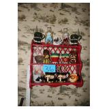 Small red shelf with decorative cups and bottles
