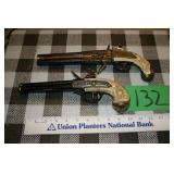 two double-barreled turnover replica pistols