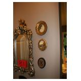 Gold trimmed mirror and circle portraits