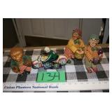 Two clown figurines, a motorcycle toy and monkey