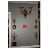 Ornate golden frames, brass sconces, wall lamp