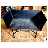 LODGE CAMPING COOK GRIDDLE & UPPER FOLDING COVER LEGS FOLD - UPPER LEFT SIDE OF GRIDDLE EDGE IS BROKEN OFF - YELLOW BASKET & WHITE RACK -   (UPSTAIRS)