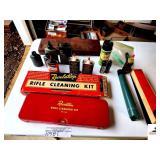VINTAGE REVELATIONS RIFLE CLEANING KIT- IN RED METAL CASE-IN ORIGINAL BOX-BOX HAS TEAR-VINTAGE METAL AND PLASTIC GUN CLEANING CAN-REVELATIONS GUN OIL-ARMY CANS OIL-10 POWER TELESCOPE-BROKEN(GARAGE)