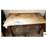 WORK SHOP TABLE PLYWOOD TOP WITH PIPE LEGS - TOP IS WORN - 52" WIDE X 26 1/2" DEEP X 28" TALL - NO INVENTORY INCLUDED - TABLE ONLY - (SHOP)