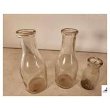 2 VINTAGE MILK BOTTLES - SMALL MILK BOTTLE SMALL MILK BOTTLE HAS CHIP - NO. 28 ON BOTTOM & L STAMP - (GARAGE)