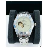 LADIES WRIST WATCH STYLED TO RESEMBLE ROLEX OYSTER PERPETUAL DATEJUST- WORKS- SWISS MADE- SILVER BRACELET W/ SILVER RHINESTONE FACE- GOLD INSIDE MECHANICS- PROMINENT NON AUTHENTIC ROLEX FEATURE IS OPE