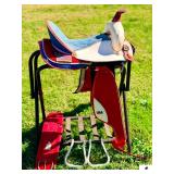 SADDLE KING WESTERN SADDLE #122415- RED, WHITE, & BLUE DECORATIVE SADDLE- BLUE SUEDE STITCHED SEAT- CLOTH SKIRTING & FENDERS W/ U.S.A. LEATHER INSERTS- WHITE PLASTIC STIRRUPS- BROWN HORN- BIG HORN TOU