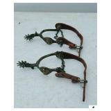 PAIR OF VINTAGE METAL RIDING SPURS WITH LEATHER STRAPS AND HEEL CHAINS
