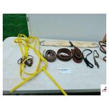 SADDLE GIRTH- (3) GIRTH STRAPS- (2) LEATHER BUCKLE STRAPS- SPUR STRAP- NYLON TRAINING HALTER WITH BROKEN BIT & REINS