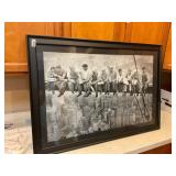 Framed photo of men working on high beam.
