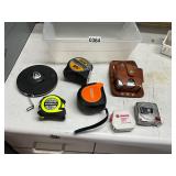 7- tape measures in plastic tote
