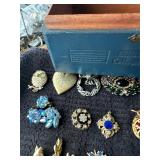 Wooden box with assortment pins/brooches