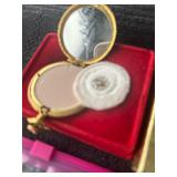 Gold colored mini powder compact