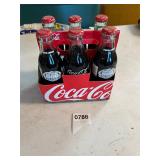 12 assorted Coke and Pepsi bottles