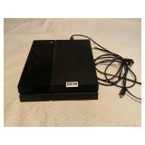 PlayStation 4 game console and power cord