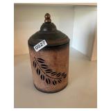 Ornate metal canister feather design