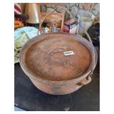 lidded cast iron footed bean pot? Marked 12