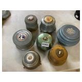 7 vintage wind up powder boxes some work