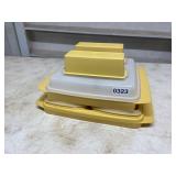 4 yellow pieces of Tupperware storage