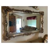 Beautiful, ornate, framed mirror and flowers