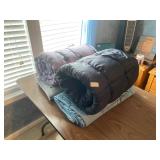 Two sleeping bags, two moving blankets