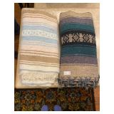 Two woven throw blankets