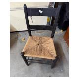 Black wooden and wicker bottom chair