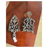 2 cast iron trivets