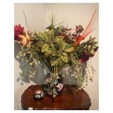 Black flowered vase with flowers and greenery