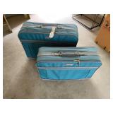 Two blue American Tourister suitcases